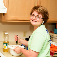 Woman stirring in kitchen